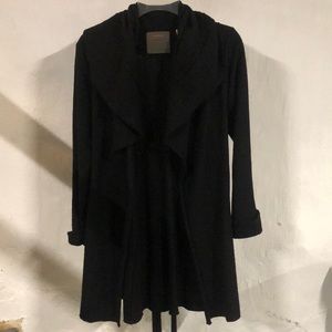 Black hip length cardigan with ruffle collar. From Anthropologie